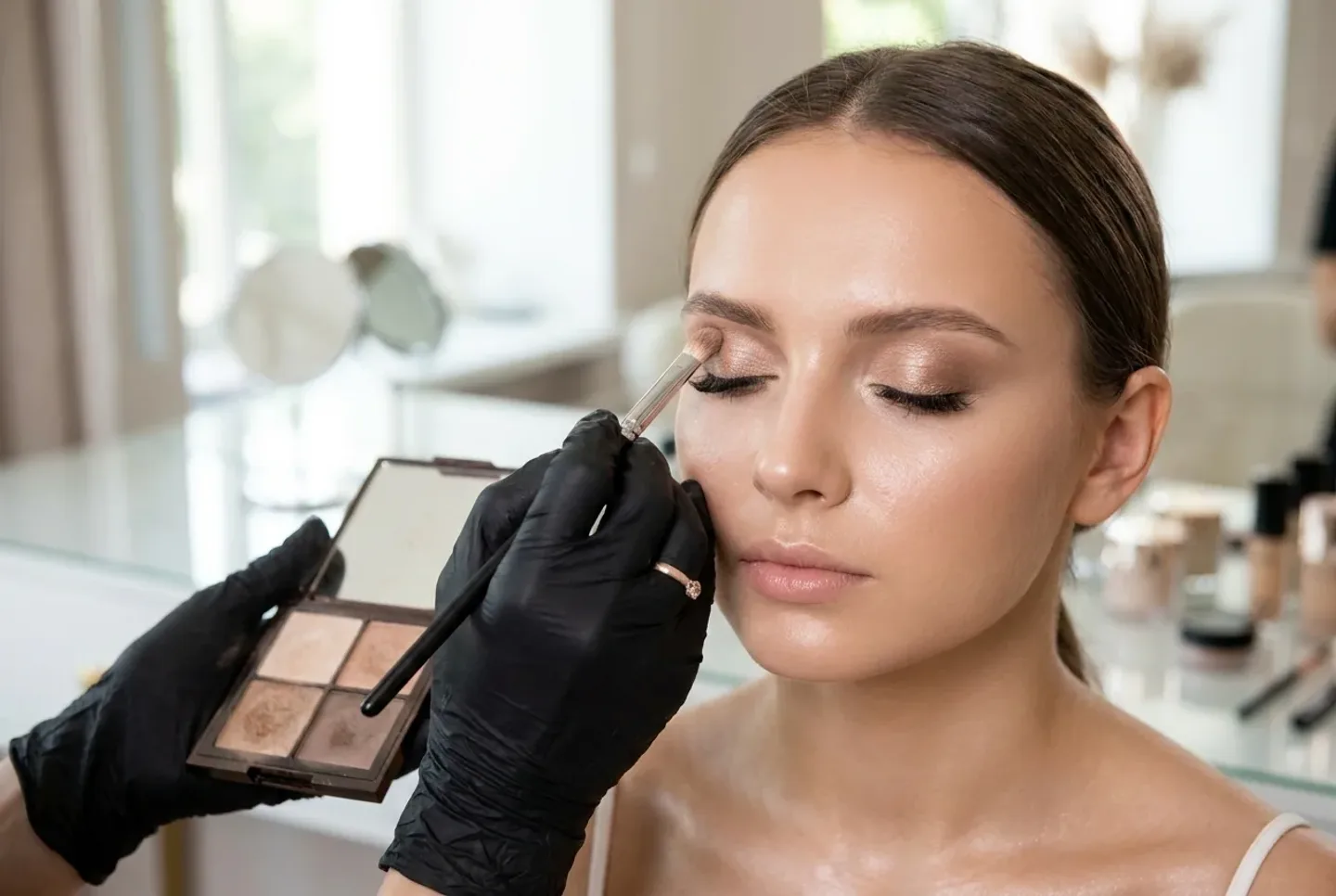 Makeup artist perfecting a soft bridal look